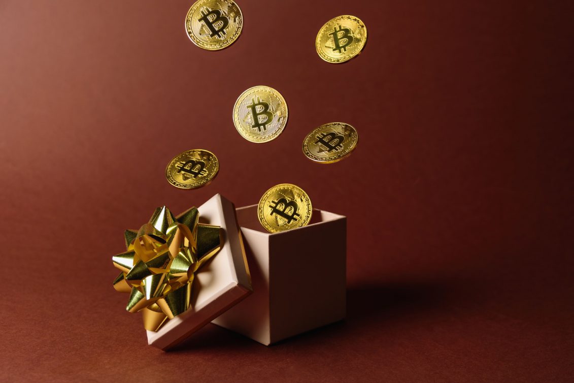 gift box with flying bitcoins utc