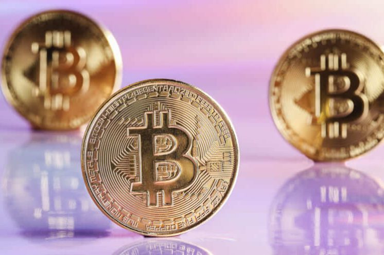 golden bitcoin coins on holographic neon backgrou utc