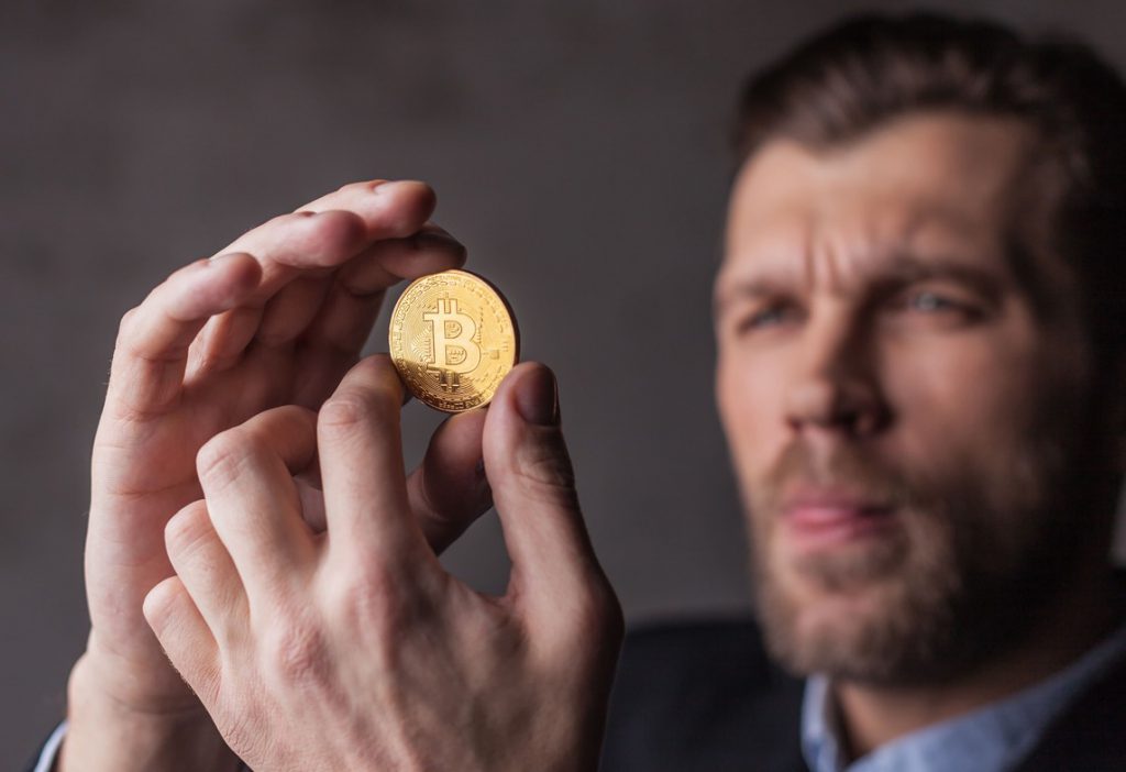 man holds bitcoin in hands
