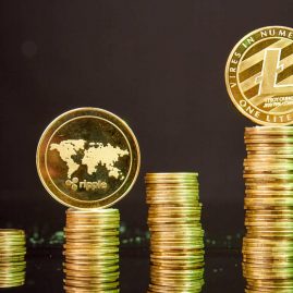 stacks of litecoins and ripple coins on dark backg